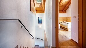 A staircase leading to a bedroom with a wooden ceiling and a skylight. - Holiday Apartment 'Thusnelda C' with Mountain View, Balconies & Wi-Fi (Seis am Schlern)