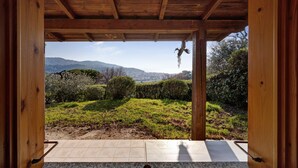 A wooden structure with a view of a grassy landscape and mountains. - New Management Holiday Home Villaggio Colombo V3 with Garden & Shared Pool (Andora (SV))