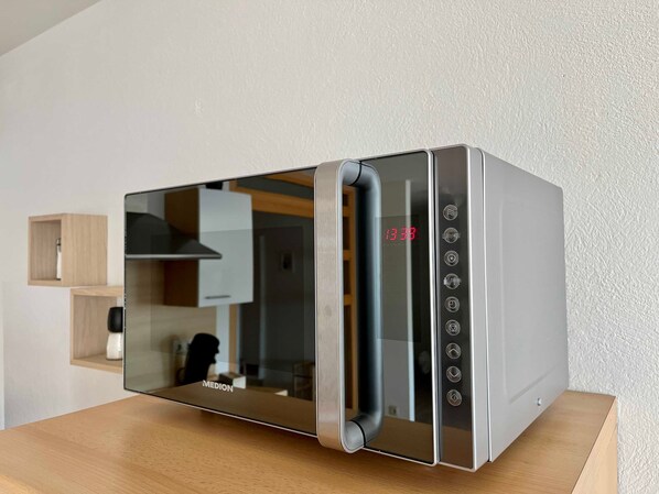 A modern kitchen with a built-in microwave oven.