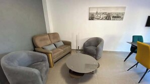 A living room with a sofa, two armchairs, a coffee table, and a dining table with chairs. - Les Marronniers, Six-Fours-les-Plages / 10 min from the beach, 4-room, 78 m² (Six-Fours-les-Plages)