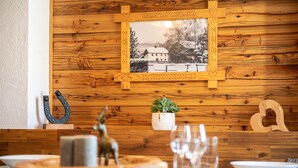 A wooden wall with a framed picture, a horse-shaped decoration, a small potted plant, and a wooden heart-shaped ornament. - Quaint, rustic vacation home with hut flair on the sunny side of the Grimming (Mitterberg-St.Martin)