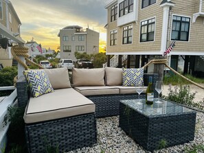 Relax in a cozy outdoor seating area with a comfortable sofa set and coffee table.