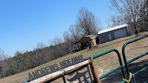 A wooden sign with the text "ANDREWS HIDEAWAY" and a silhouette of a house. - Quaint Country Cabin - Experience the Ozarks (CALICO ROCK)