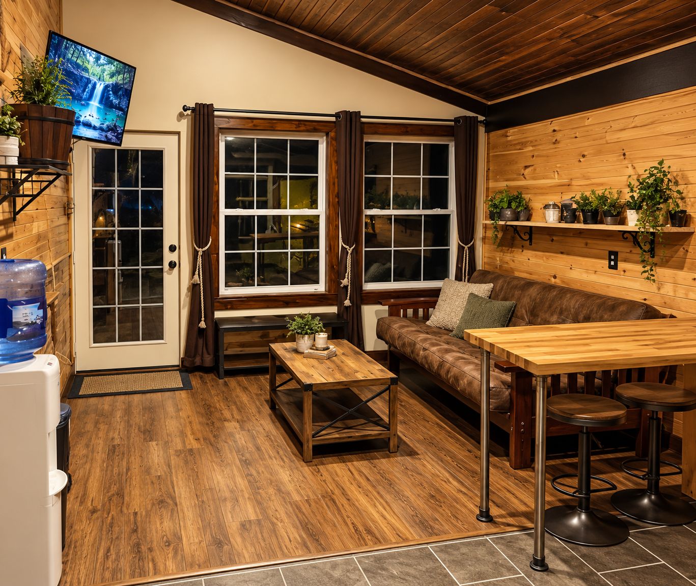 A cozy interior with a wooden bench, a small table, and a bar area with stools.