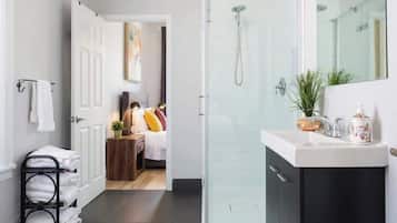 Bathtub, hair dryer, towels, shampoo