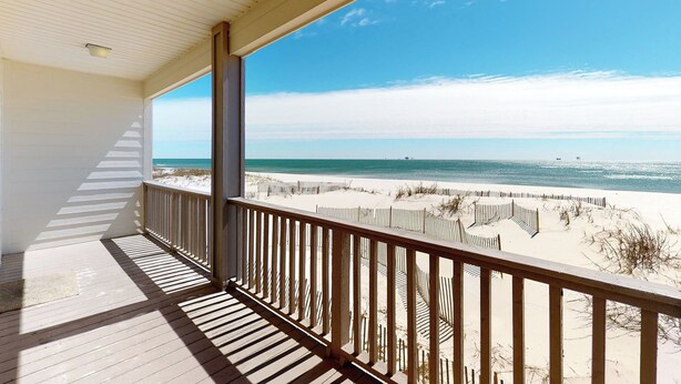A wooden deck with a railing overlooking a beach with sand dunes and the ocean. - Fort Sun, West. Gorgeous 7BR Beachfront. Extra fridges. Private Pool! Sleeps 24. (Gulf Shores)