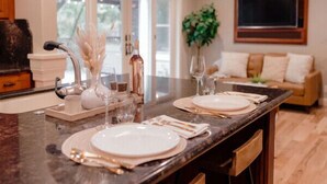 A modern kitchen with a central island, bar stools, and a ceiling fan. - Luxury Home, Hot Tub Walk To Downtown Nevada City (Nevada City)