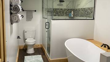 Bathtub, hair dryer, towels, toilet paper