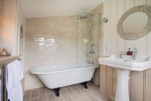 Combined shower/bathtub, towels, soap, toilet paper
