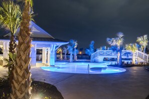 Relax by the pool surrounded by lush tropical plants and a serene atmosphere.