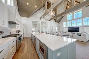 Enjoy cooking in this well-equipped kitchen with a central island, ample counter space, and integrated appliances.