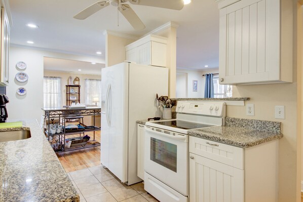 Enjoy cooking in this well-equipped kitchen with a refrigerator, oven, and microwave.