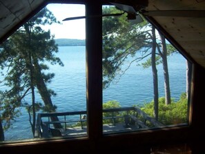 A cabin with a view of a lake and trees.