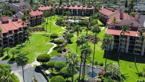 A resort with multiple buildings, a central pool, and well-maintained gardens.