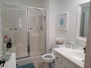 Combined shower/bathtub, towels, soap, toilet paper