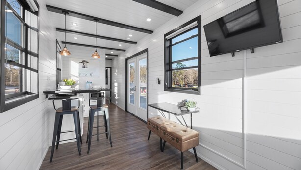 A modern kitchen with a central island, pendant lighting, and a large window. - Combo Plate: 2 mins to Lake Conroe! Heated Pool, Stocked Ponds, Cute Pygmy Goats (Willis)