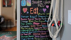 A wall with a chalkboard listing local attractions, eateries, and shops in Denver. - Music Lover’s Getaway - Red Rocks + Denver (Wheat Ridge)