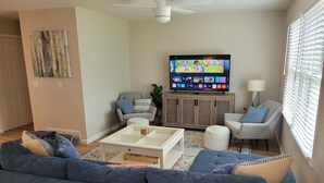 A living room with a sofa, chairs, a coffee table, a TV, and a cabinet. - White Birch - Riverfront and Newly-Remodeled!  Great Location! (Elberta)
