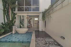 A modern bathroom with a freestanding bathtub, a small shower area, and a tiled floor. - Aeera Villa Canggu by Ini Vie Hospitality (Canggu)