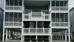 A multi-story building with a covered entrance and balconies.