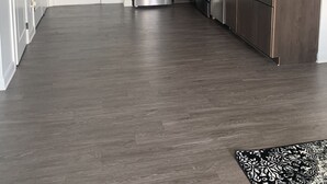 A modern kitchen with dark wood cabinets, stainless steel appliances, and a black pendant light. - TOP FLOOR DOWNTOWN CONDO (Columbus)
