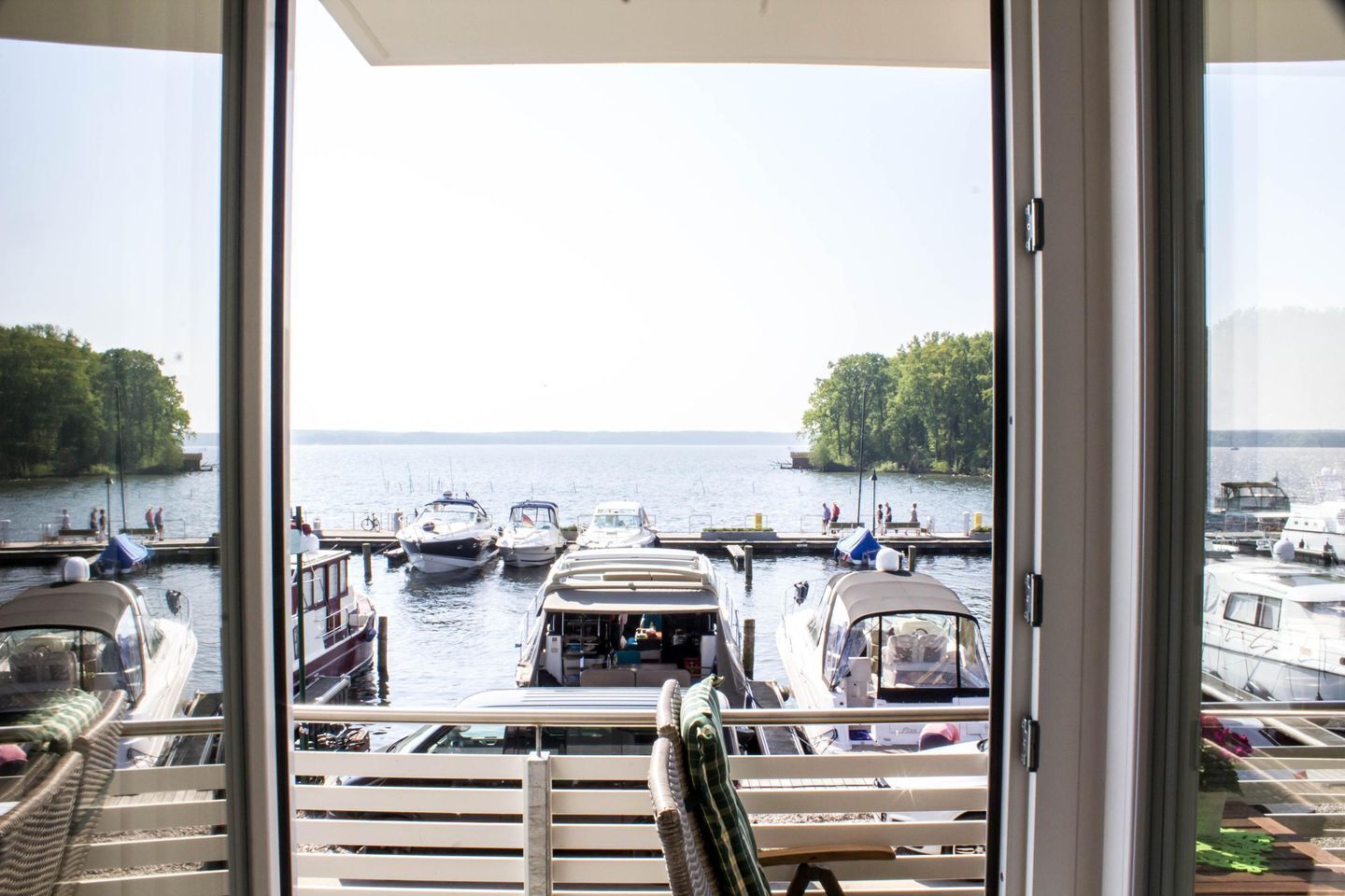 A view from a balcony overlooking a marina with several boats docked.