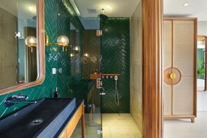 A modern bathroom with a glass shower enclosure, a wooden vanity, and a large mirror. - Monolocale Resort & Spa Seminyak by Ini Vie Hospitality (Keroboken Kelod)