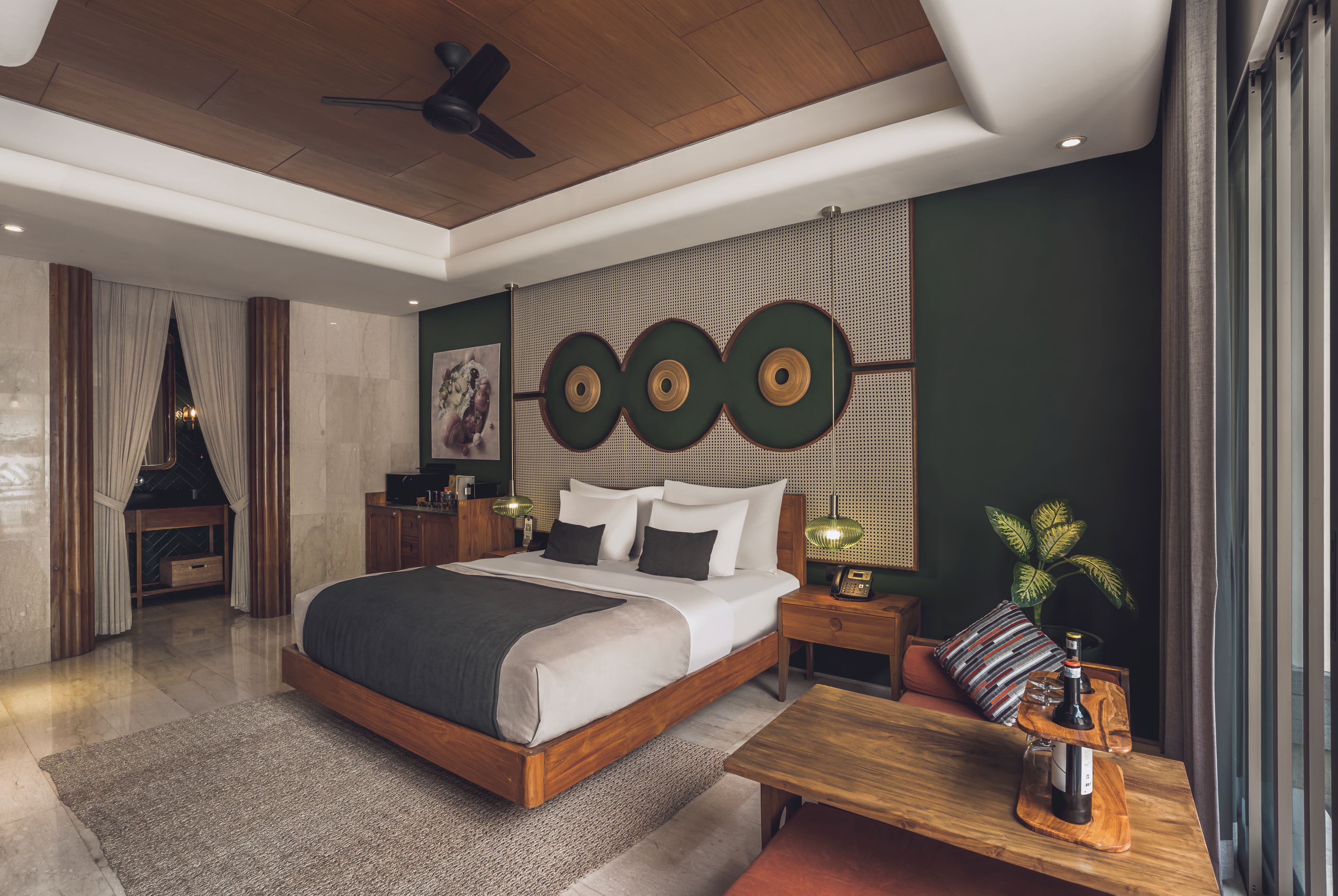 A modern bedroom with a large bed, bedside tables, a wooden ceiling, and a wall-mounted light fixture.