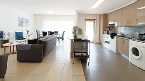A modern apartment with a living area, dining space, and kitchen.