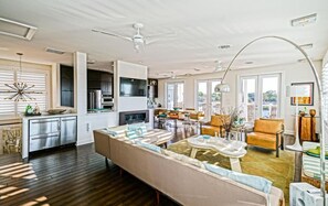 A spacious living area with a large sofa, a dining table, and a kitchen in the background. - Simply The Best - At Angler's Nest! (Lewes)