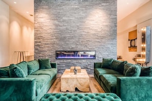 Relax in this stylish living room with a flat-screen TV, two comfortable sofas, and a coffee table.