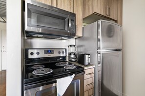 Enjoy cooking in this fully equipped kitchen with a microwave, oven, refrigerator, coffee maker, and toaster.