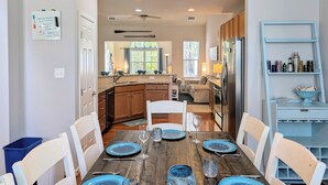 A modern kitchen with wooden cabinets, a built-in oven, and a stainless steel refrigerator. - Spacious 4BR Forest Landing Duplex - Dog Friendly, Pool & Trails! (Frankford)