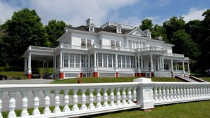A large, white, two-story building with multiple balconies and a covered front porch. - O'Connors Retreat - Blowing Rock, Hot tub Secluded acreage, fabulous views (Lenoir)
