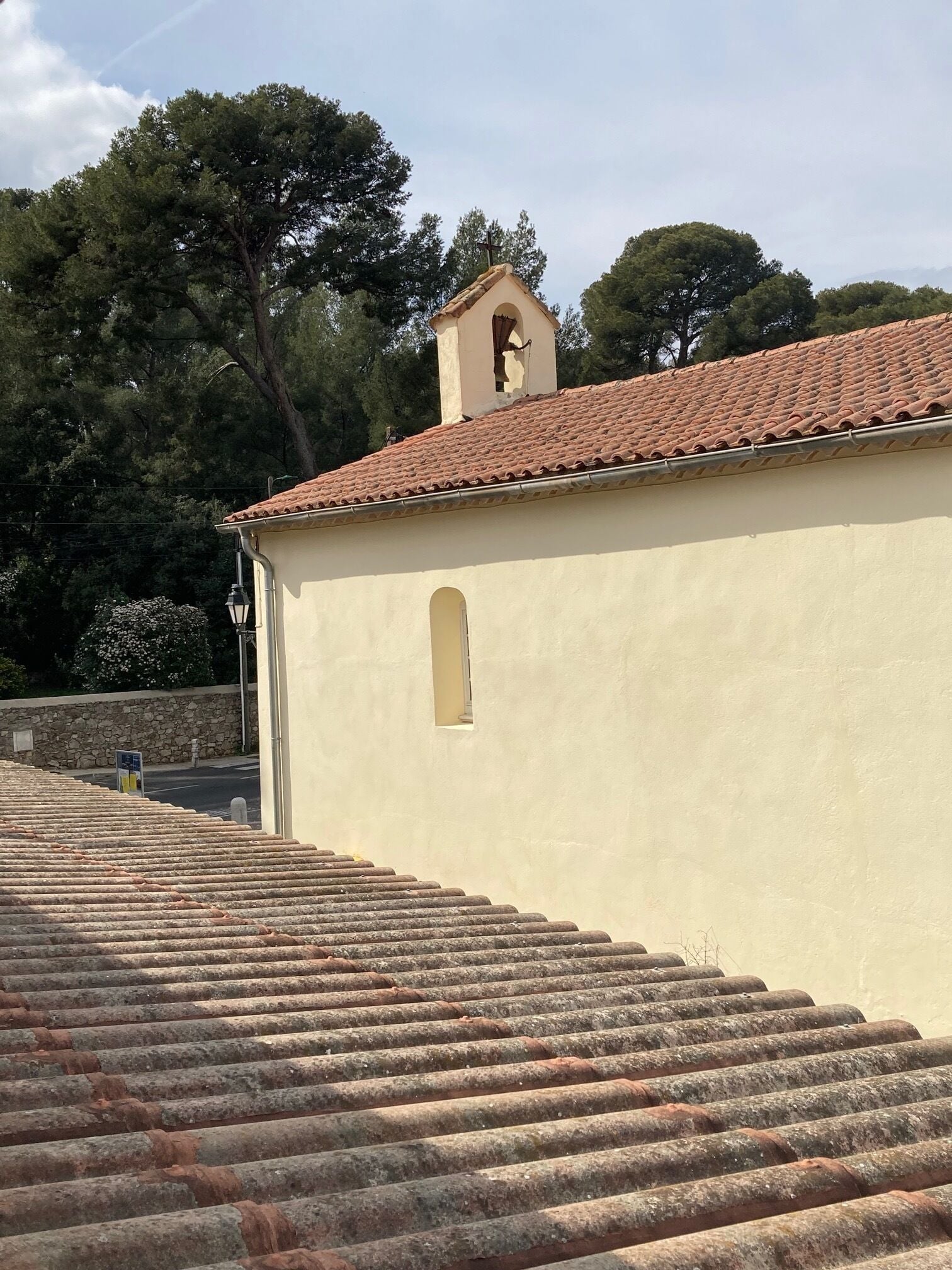 A building with a tiled roof and a bell tower.