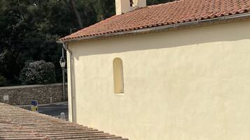 A building with a tiled roof and a bell tower.