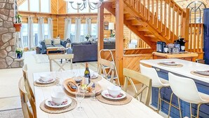A cozy cabin interior with a dining area, kitchen, and living space. - The Lakefront Lodge near CHQ Institution (Mayville)