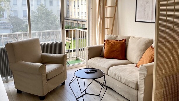 A modern living room with a sofa, armchair, and a geometric coffee table. - New Studio - City Center Mulhouse - Near Train station (Mulhouse)