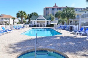 A swimming pool with lounge chairs and a building in the background. - Shorehaven Lakefront & Steps to Beach w Pool (North Myrtle Beach)