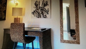 A room with a desk, chair, lamp, and a large mirror with a decorative frame. - Auberge Sainte Marguerite - "Anse Méjean" room (La Garde)