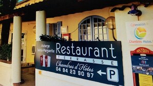 A restaurant sign with the name 'Restaurant' and 'Chambres d'Hôtes' indicating a hotel restaurant. There is a parking sign with a 'P' symbol. - Auberge Sainte Marguerite - "Anse Méjean" room (La Garde)