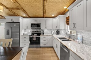 Fridge, microwave, oven, stovetop - Tiki Cottage: 2.5 Blocks to Beach, Pool with Swim up Tiki Bar by Anna Maria Live Vacation Rentals (Holmes Beach)