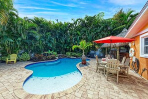 A heated pool, sun loungers