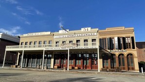 Un bâtiment historique abritant plusieurs commerces, notamment « Pacific Rail Road » et « Huntington & Hopkins Hardware ».