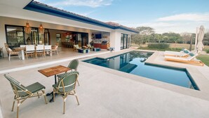 A modern house with a pool, outdoor seating, and a patio area. - Casa Palmeras • Luxury Villa Near Beach & Surf (Tamarindo)
