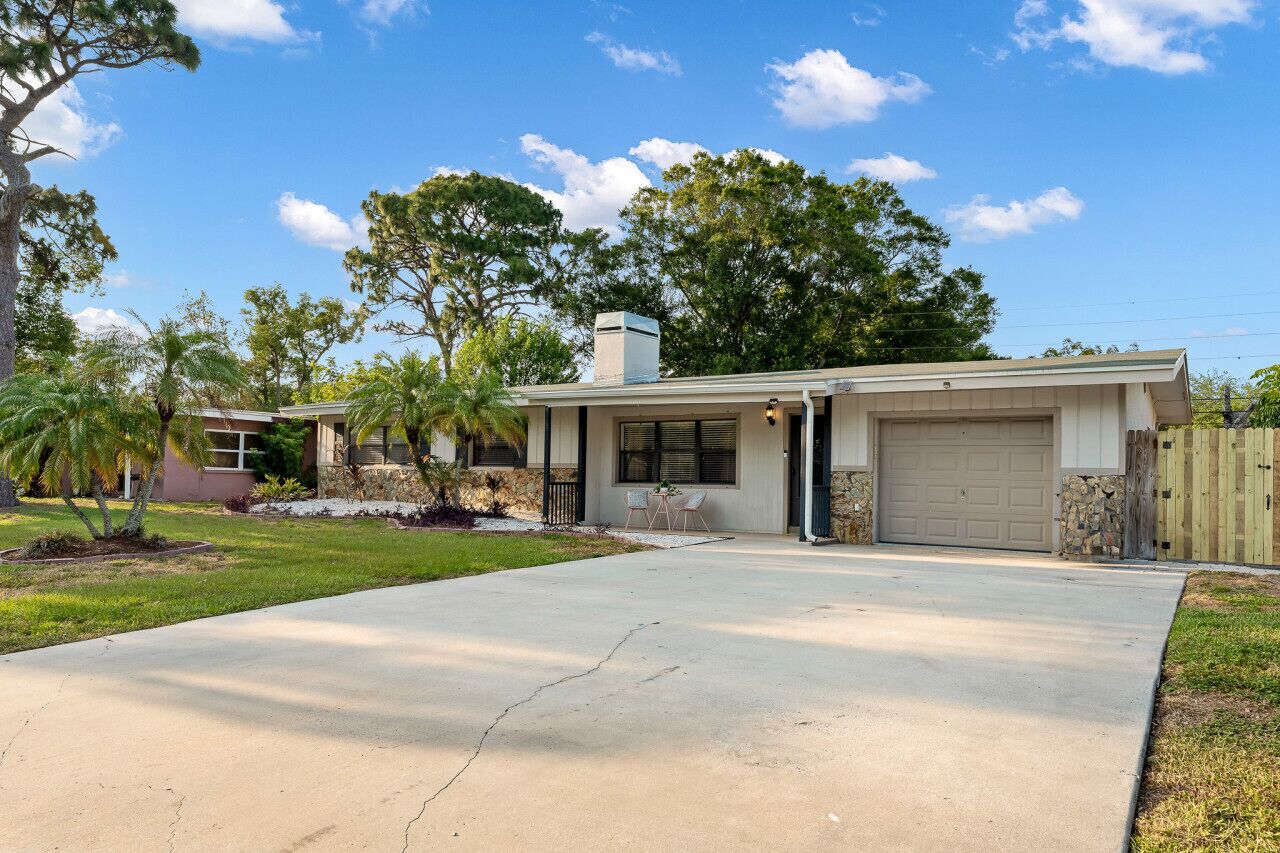 A single-story house with a garage, a front porch, and a driveway.