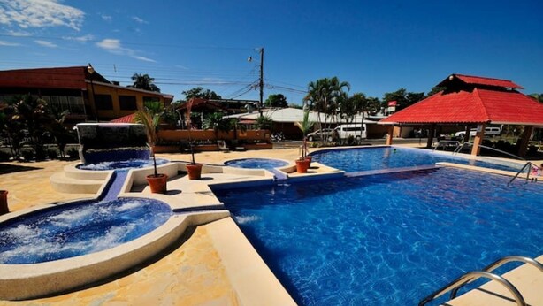 A swimming pool with multiple sections and a surrounding patio area. - Small romantic getaway to remind people why they fell in love (Jaco)