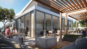 An outdoor seating area with modern furniture and a wooden pergola.