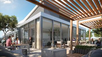 An outdoor seating area with modern furniture and a wooden pergola.