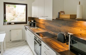 Fridge, stovetop, dishwasher, coffee/tea maker